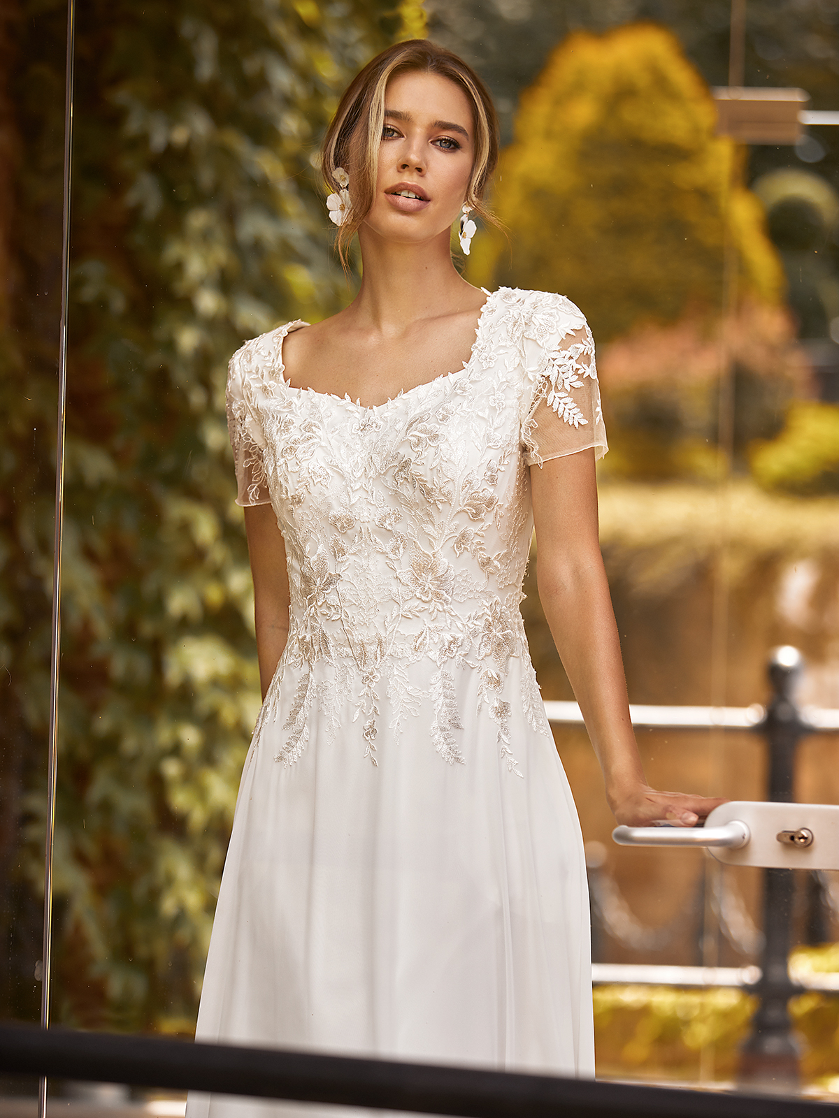 Bride wearing a simple wedding dress with sheer short sleeves