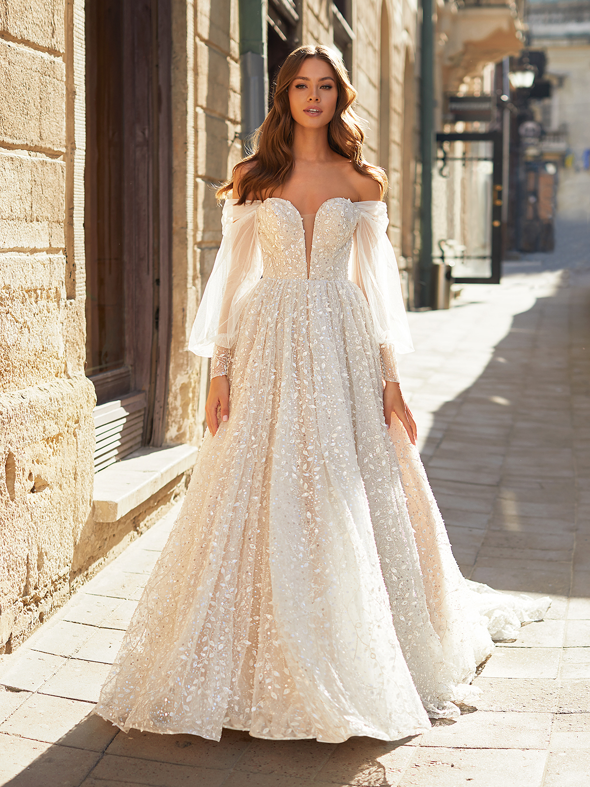Bride wearing a wedding gown with detachable off the shoulder sleeves