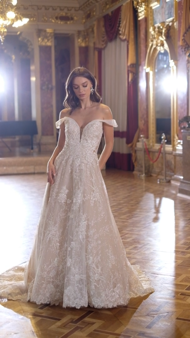 Moonlight Couture H1472 Off-The-Shoulder Silver Glitter Floral A-Line Wedding Gown With Side Bodice Cutouts Moonlight Couture H1472 Off-The-Shoulder Silver Glitter Floral A-Line Wedding Gown With Side Bodice Cutouts