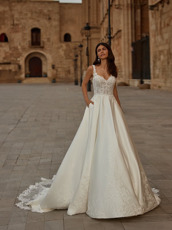 Bride Wearing Satin Ball Gown Wedding Dress With Sweetheart Neckline And Lace Straps