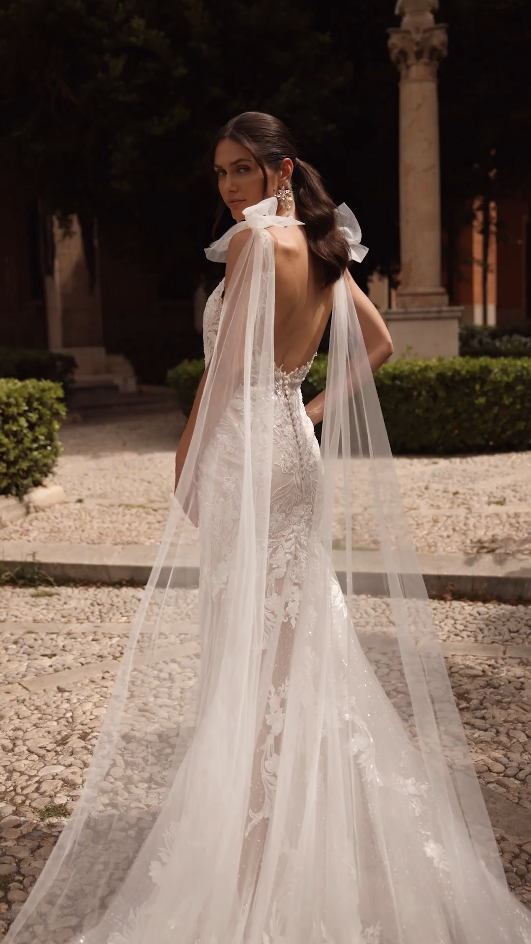 Bride Wearing A Sparkly Lace Mermaid Wedding Dress With Detachable Tulle Bow Tails