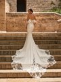 Bride Walking Up Stairs In A Wedding Dress With Shaped Illusion and Lace Cathedral Train