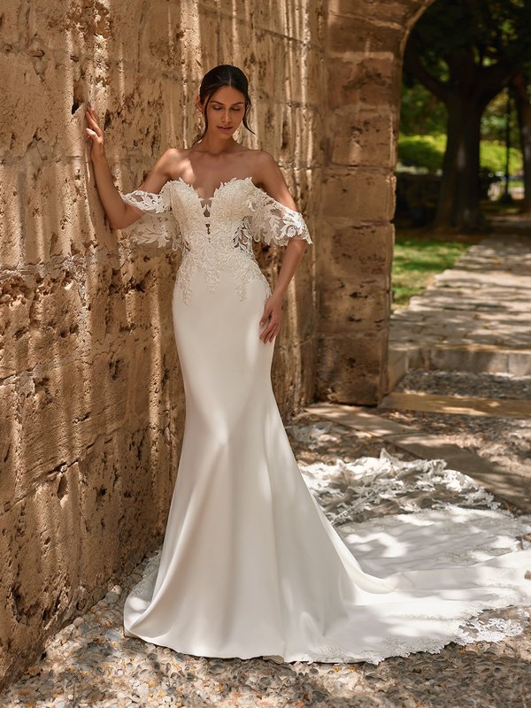 Bride Wearing A Fitted Crepe Wedding Dress With Romantic Lace Sleeves