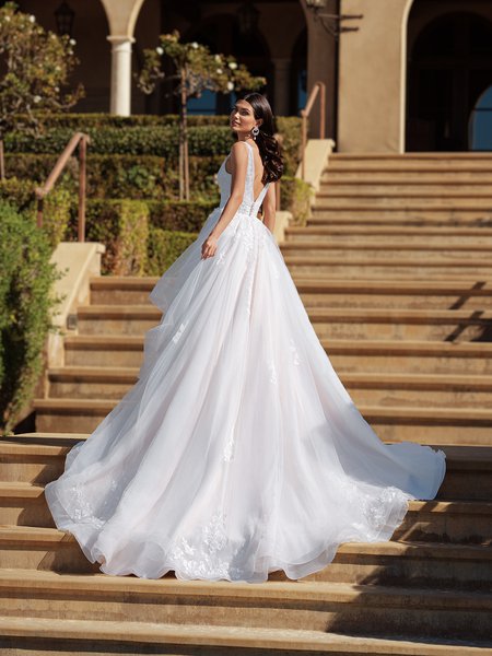 Gorgeous bride in Moonlight Couture H1587 a luxurious wedding dress featuring V-neckline, pleated bodice, 3D florals, A-line skirt, and chapel train on steps Gorgeous bride in Moonlight Couture H1587 a luxurious wedding dress featuring V-neckline, pleated bodice, 3D florals, A-line skirt, and chapel train on steps