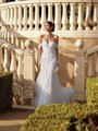 Bride in Moonlight Couture H1591 An Exquisite mermaid wedding gown adorned with 3D florals, featuring an off the shoulder neckline. A drop waist design adds a touch of elegance