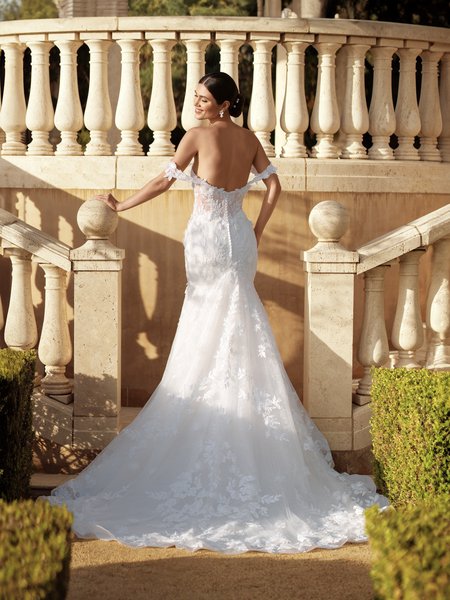 A stunning bride in Moonlight Couture H1591 an exquisite mermaid drop waist wedding dress, adorned with 3D florals. She stands gracefully on a grand staircase A stunning bride in Moonlight Couture H1591 an exquisite mermaid drop waist wedding dress, adorned with 3D florals. She stands gracefully on a grand staircase