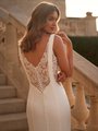 Bride Looking Over Shoulder Wearing a Low Illusion V-Back Wedding Dress With Straps