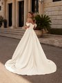 Back view of bride wearing elegant ivory satin wedding dress with scoop back and chapel train.