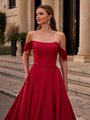 Close up view of bride wearing scoop neckline red wedding dress with pleated off the shoulder swag sleeves and small bow sash