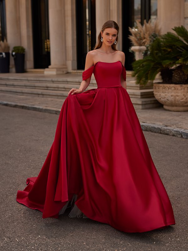 Bride walking in red A-line wedding dress with scoop neckline and off the shoulder sleeves