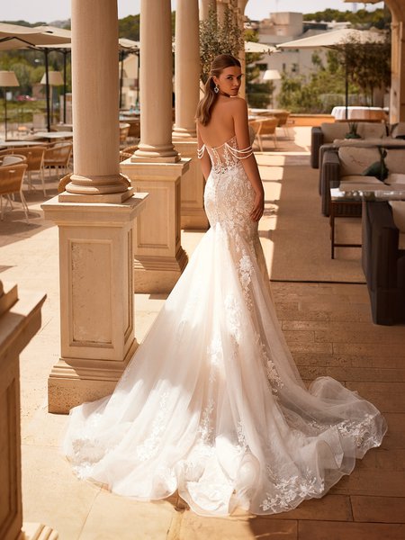 Back view of illusion v-shaped back wedding dress with detachable beaded swag sleeves and chapel train