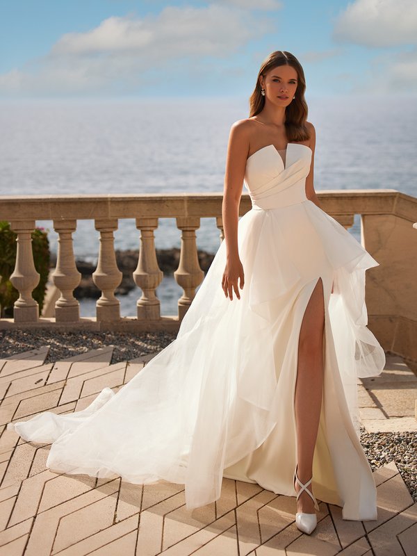 Bride wearing a sexy convertible wedding dress with detachable tulle cascade skirt