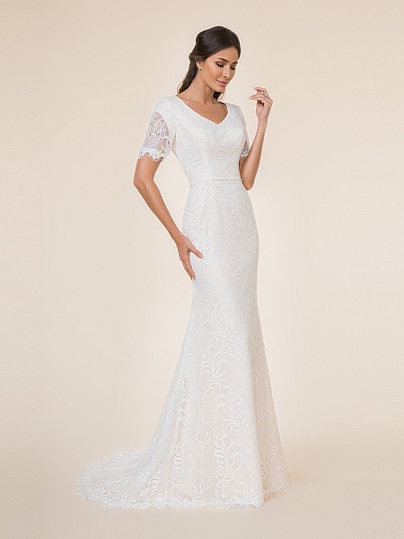 Modest mermaid wedding dress with wide v-neck, embroidered lace fabric, beaded band at waist and sweep train