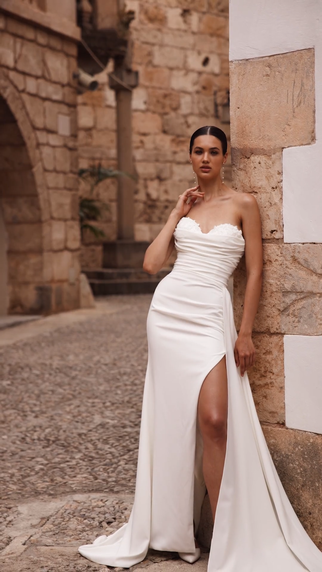 Bride wearing sexy crepe mermaid wedding dress with side leg slit and train