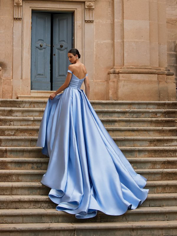 Bride walking up stairs in Cinderella blue Mikado wedding dress with chapel train