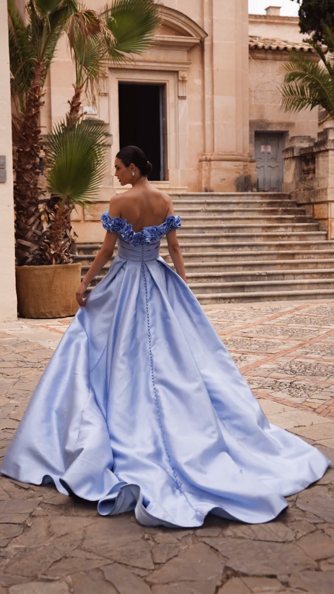 Bride wearing Cinderella blue Mikado A-line wedding dress with floral off the shoulder neckline