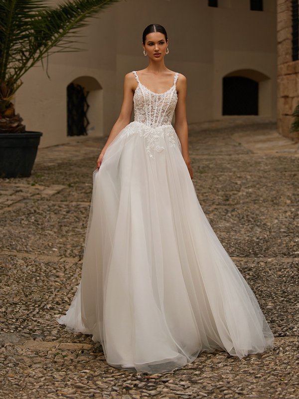 Bride wearing light weight A-line tulle and lace wedding dress with scoop neckline and Basque waistline